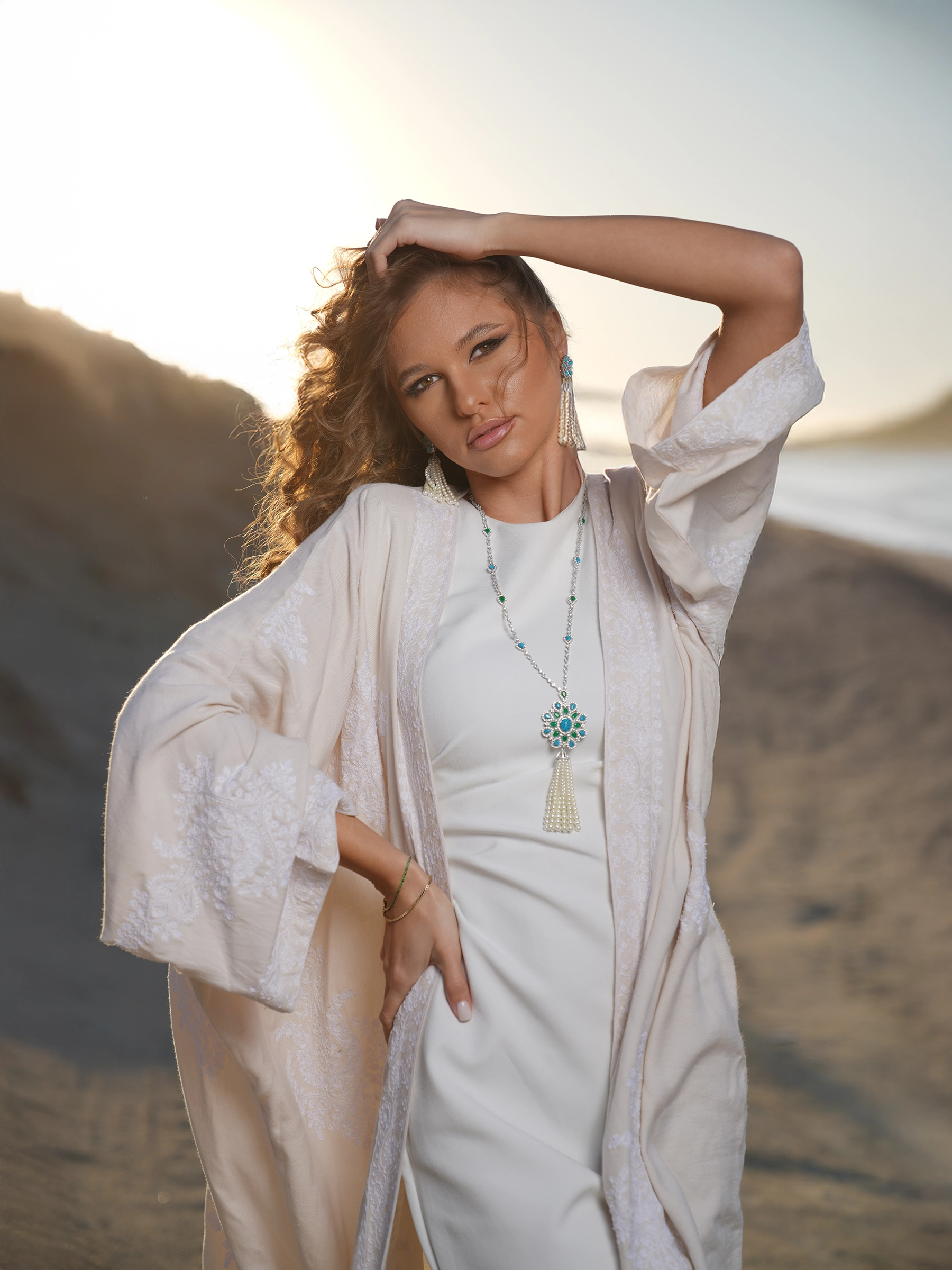 Model in kuwaiti kaftan photographed in desert at sunset in Kuwait
