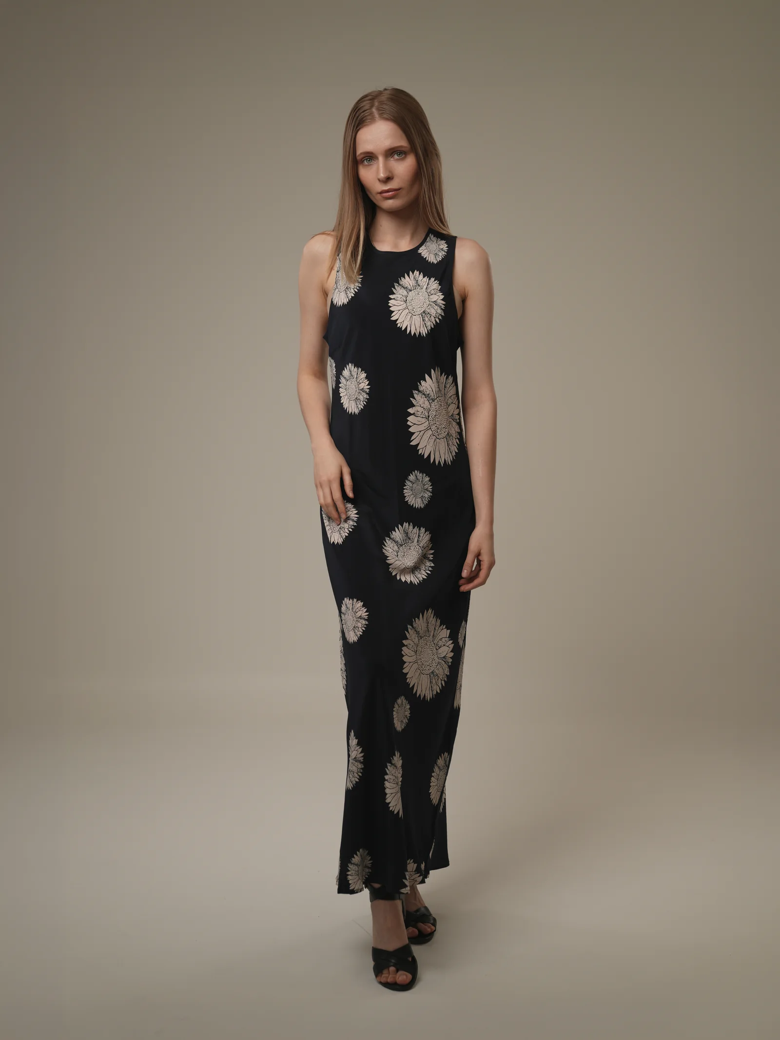 Full-length studio portrait of model in navy daisy-print maxi dress, Kuwait