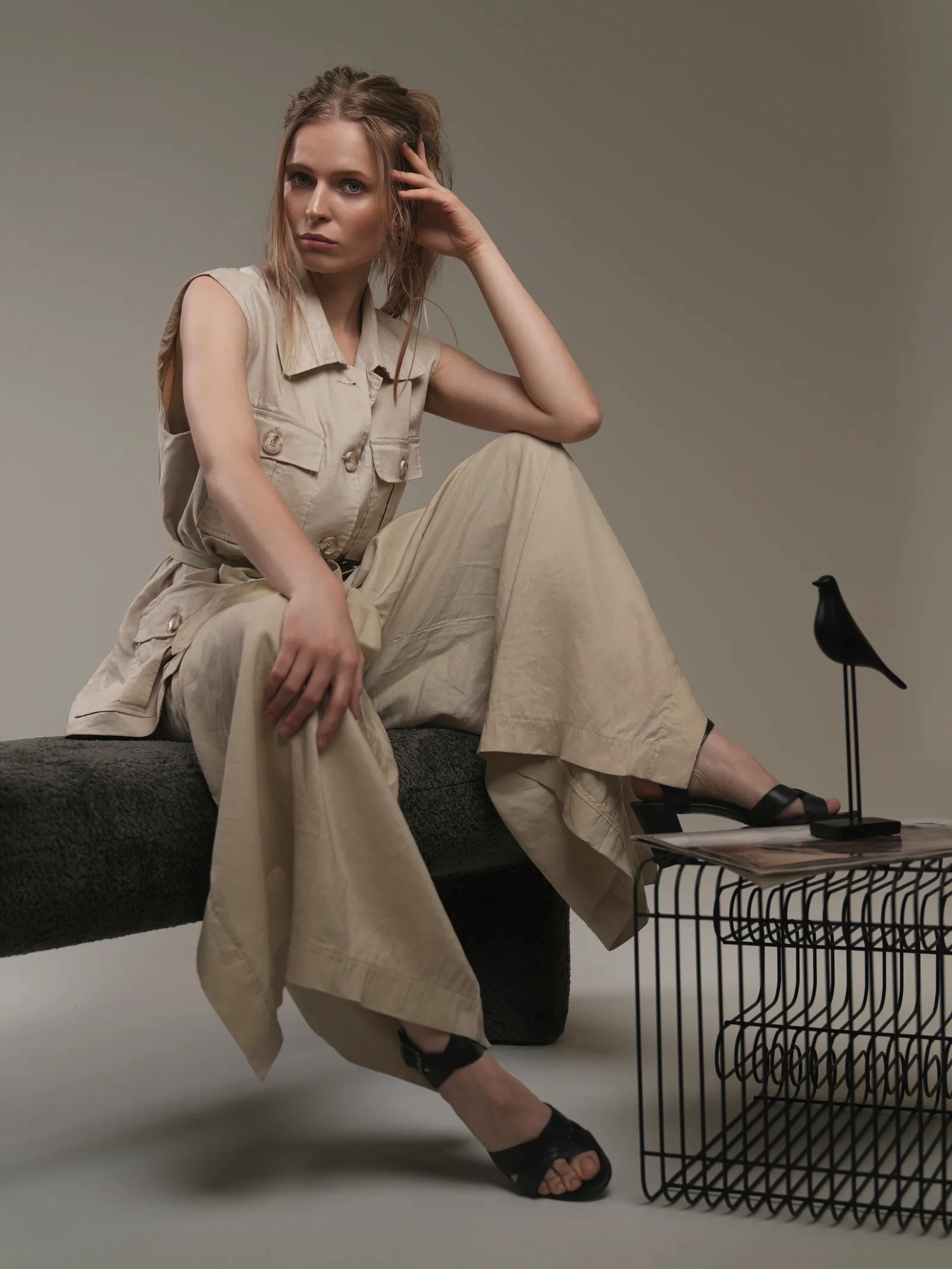 Editorial portrait of model seated in beige linen set in Kuwait studio