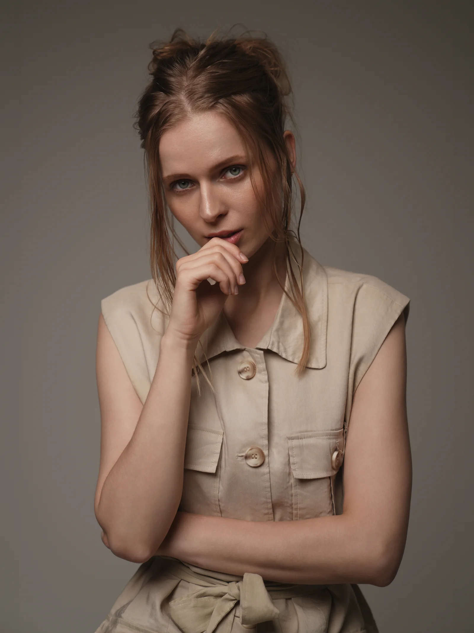 Close-up editorial portrait of model in beige linen vest by Studio Letouch