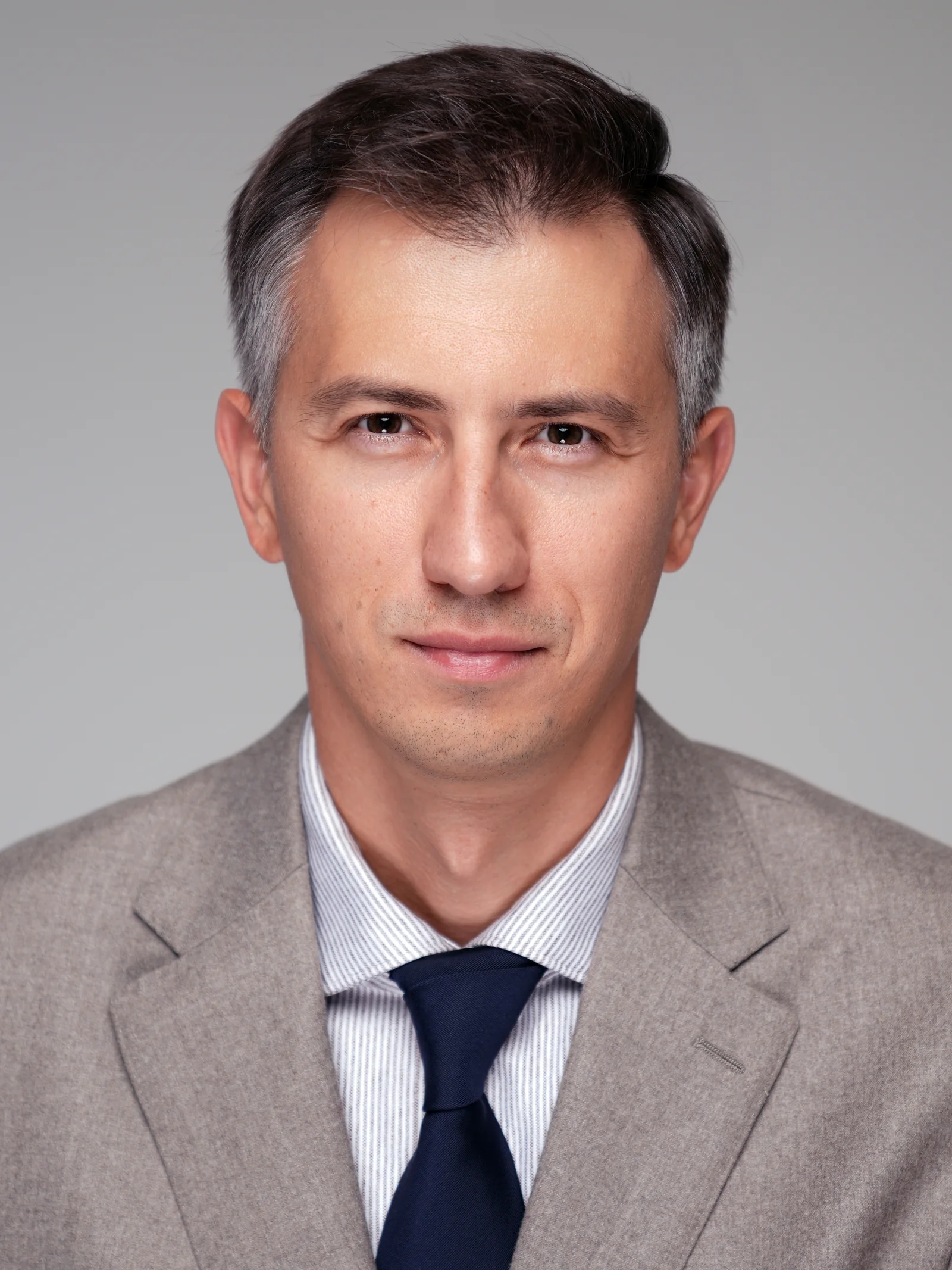 Business portrait of executive with arms crossed in Kuwait studio