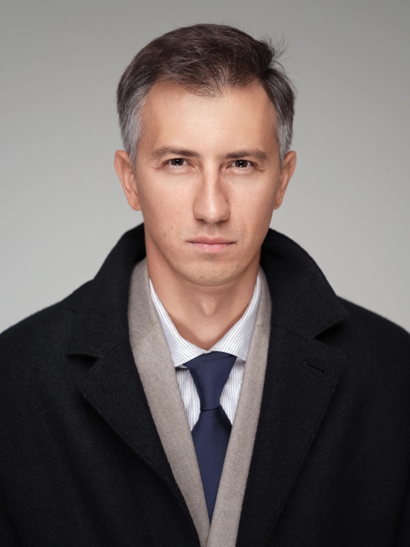Executive portrait in dark coat photographed by Studio Letouch Kuwait
