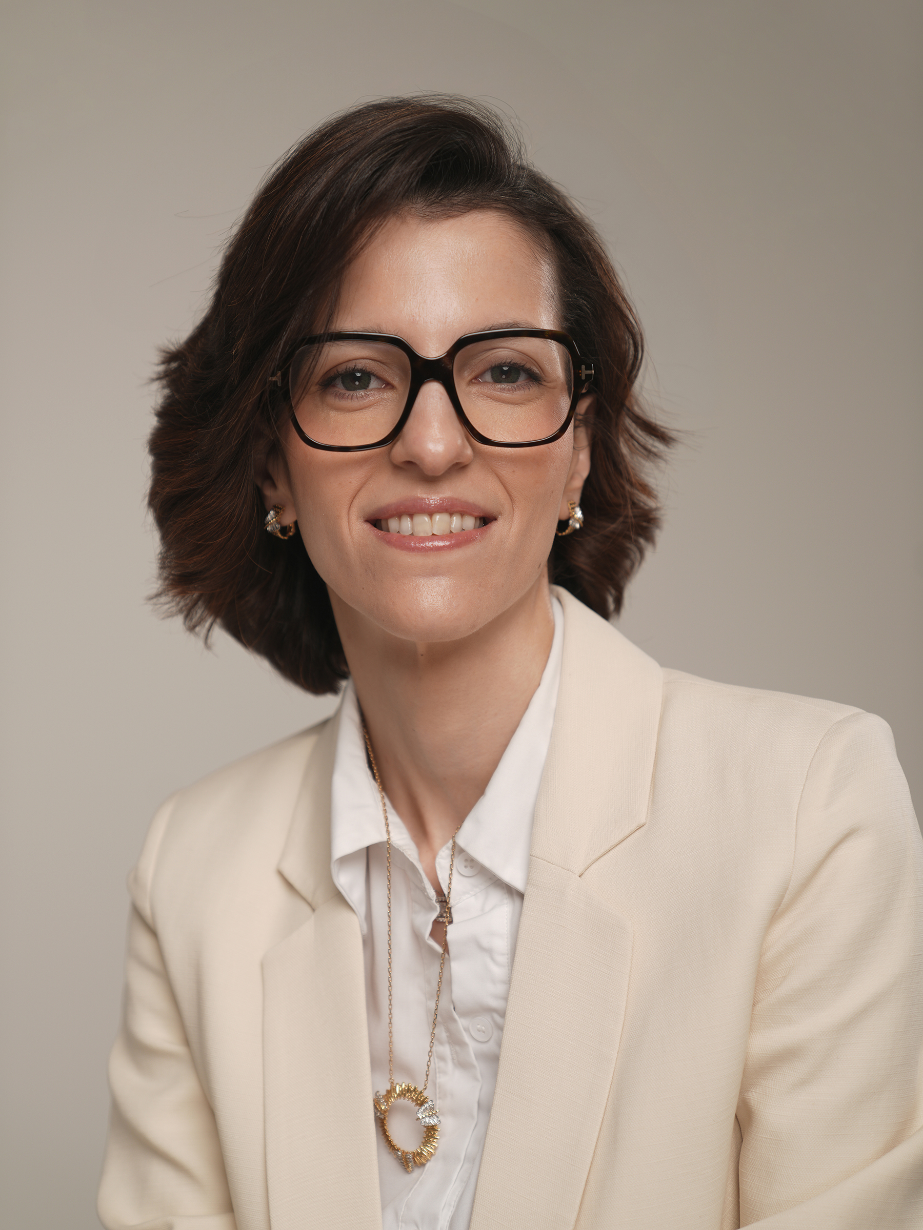 Close-up personal branding headshot in a cream blazer with a warm smile, Kuwait