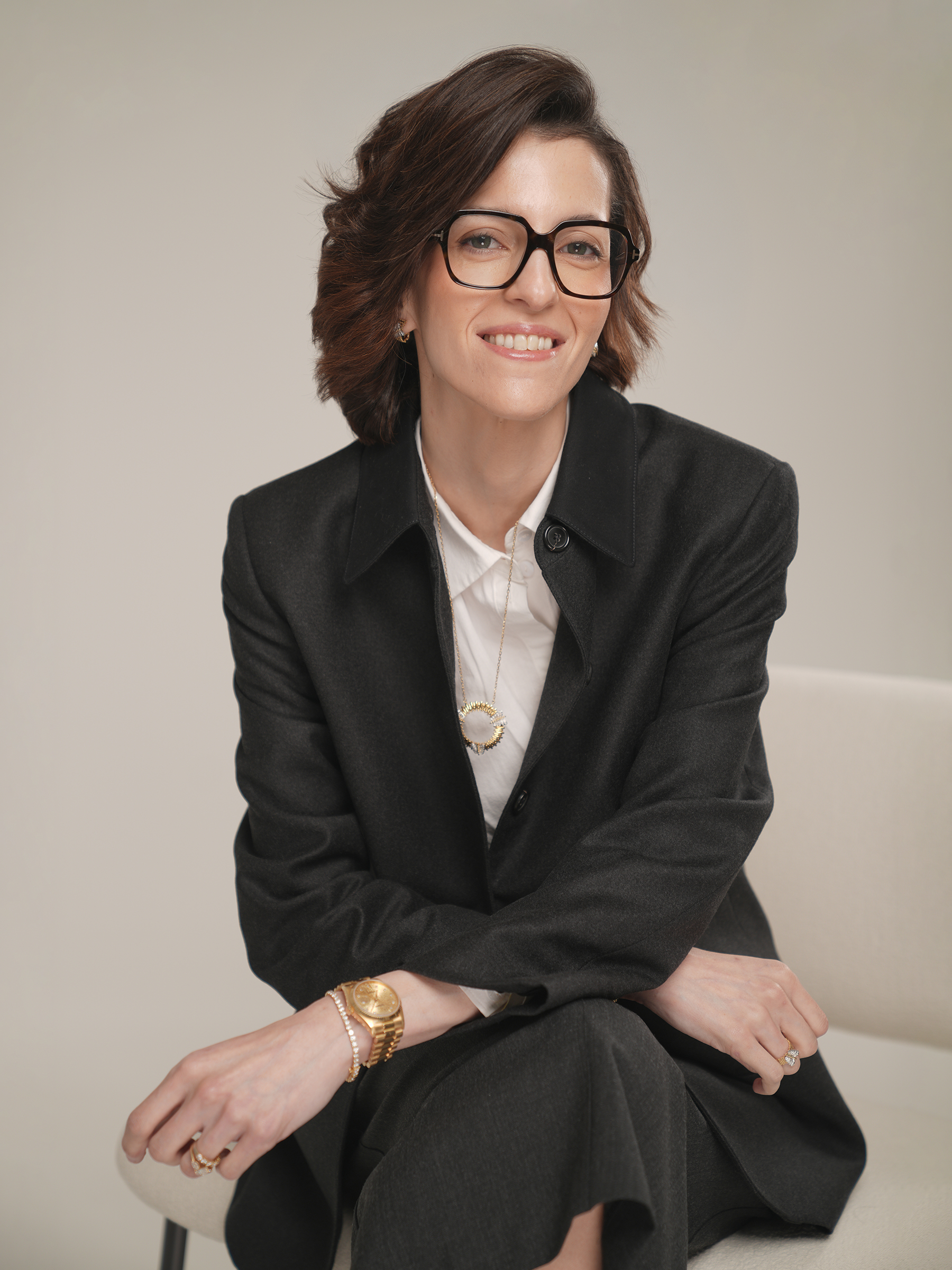 Executive personal branding portrait in a charcoal coat, seated, Studio Letouch Kuwait